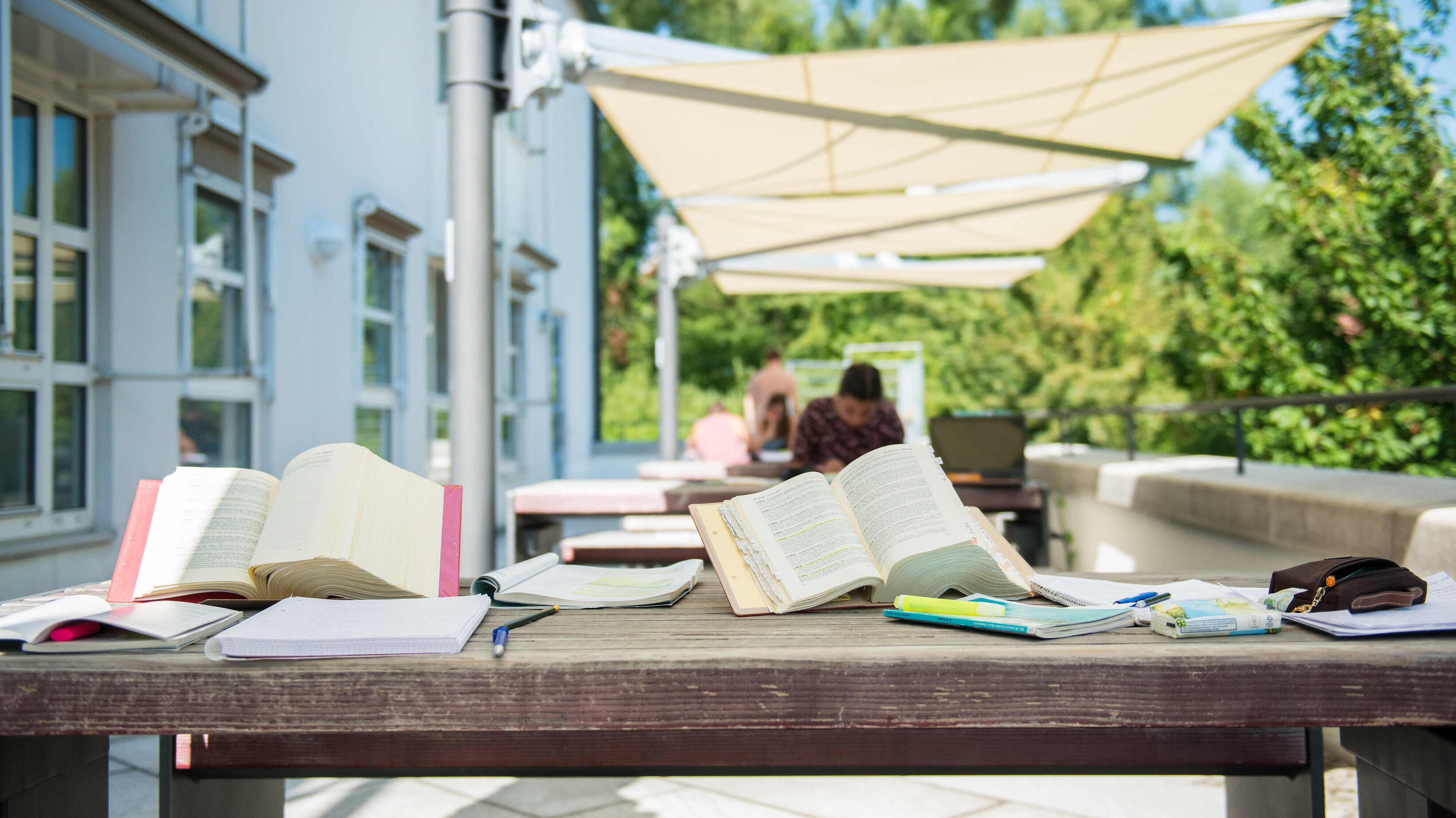 Books on a table outside the university