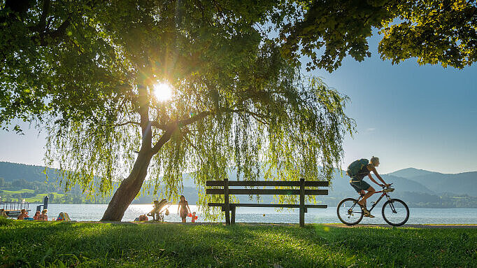 Person riding bike in front of the Tegernsee
