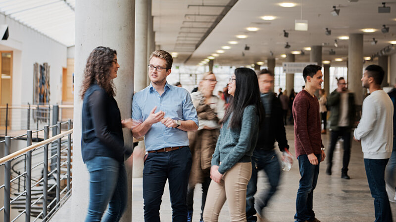 © Oliver Kussinger Students chatting on the University Campus