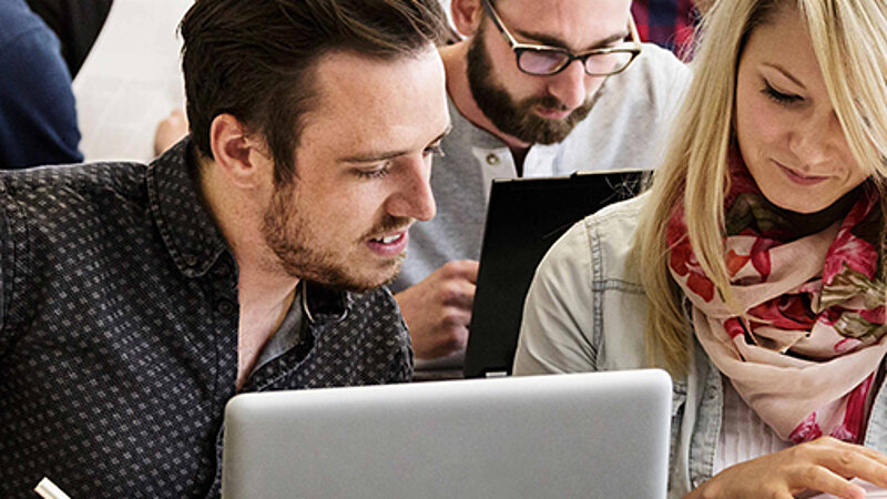 @ Landshut UAS Students a looking into a book