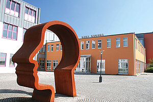 @ OTH Amberg-Weiden A university building with a head-shaped sculpture.