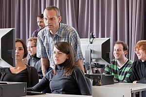 A professor and his students are collaborating on their computers