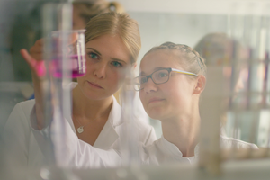 @ HWST Students checking a liquid in a lab