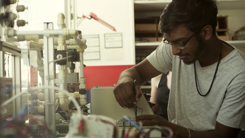 @ HWST A student in working in a lab.