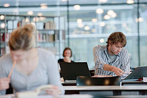 Students studying in a modern glass university