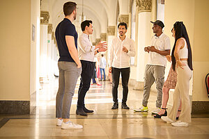 A group of international students talking in LMU's main building