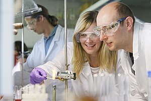 A male and a female student collaborate in the laboratory