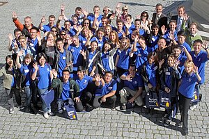 @ Kempten UAS A group of students waving their hands.